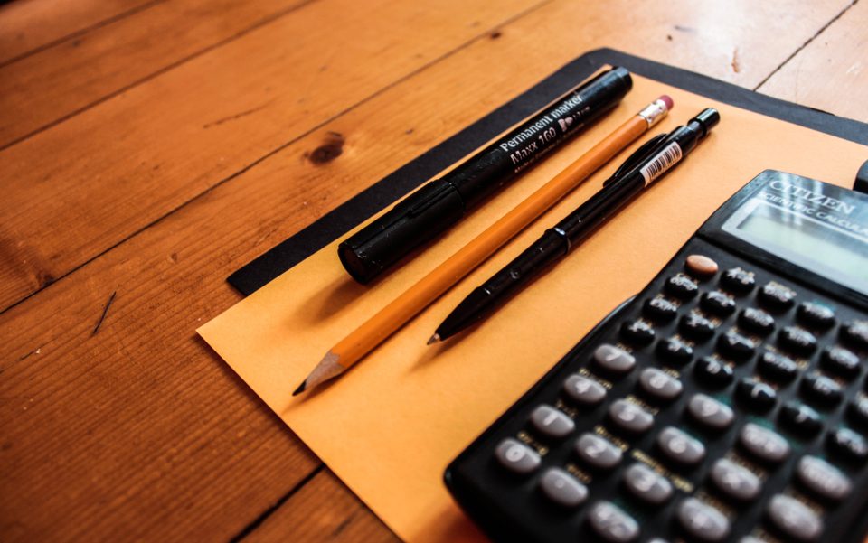 Calculator and pens on a desk